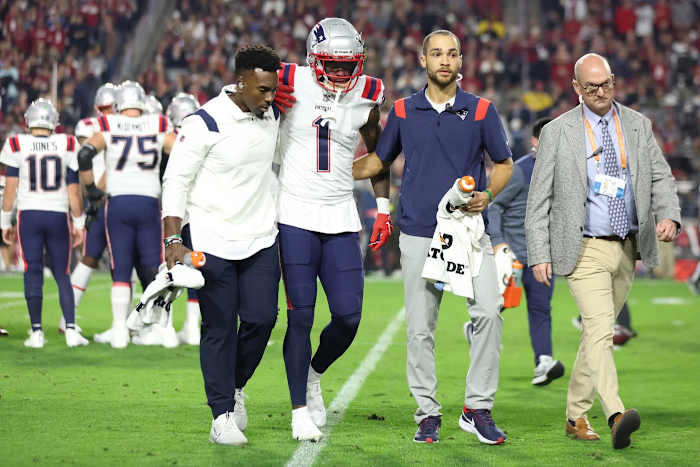 Trainers help Parker off the field during last year's game against the Arizona Cardinals.
